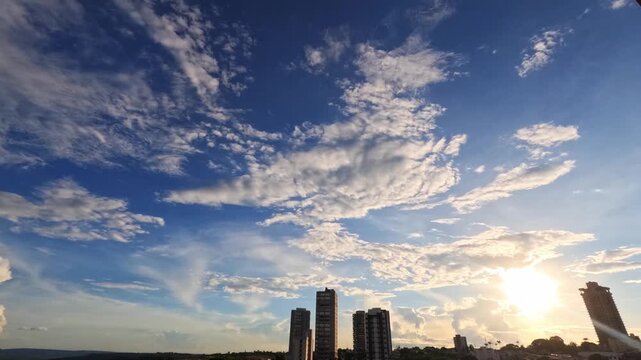 A stunning time-lapse video capturing the dramatic transition from a beautiful sunset to a full night over a modern city skyline. Watch as the sky changes from warm golden hues to deep blue, with clou