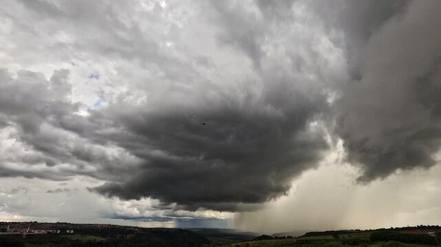 Dramatic black and white time-lapse of ominous storm clouds gathering and moving swiftly across the sky, revealing the power of a severe weather system.