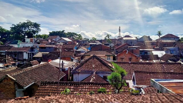 High Angle View of Dense Urban Residential Rooftops under Blue Sky