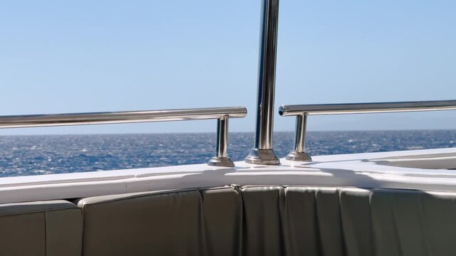 Upper deck railing close up and seating area of a yacht