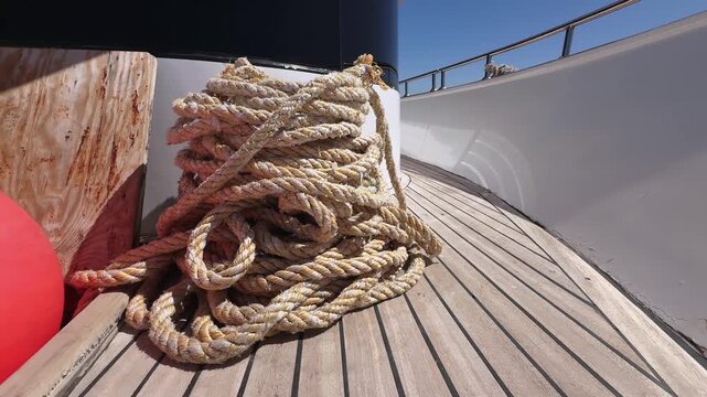 Close up of Mooring ropes and yacht deck prepared for anchoring in the sea