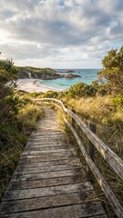 Fototapeta premium Scenic wooden pathway leading to sandy beach with ocean view 