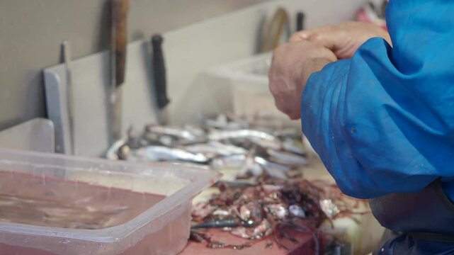 Fisherman preparing fresh fish at a seafood market