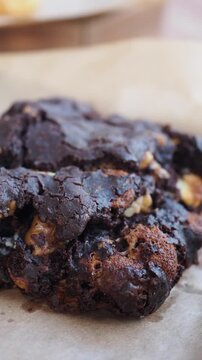 Perfectly baked chocolate chip cookies on brown paper