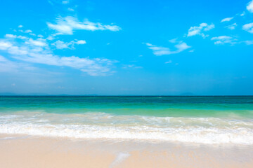 Obraz premium Tropical Nature clear sky and summer sea water under a clear blue sky with beautiful clouds and bright sunlight. Perfect for summer vacation and travel background 