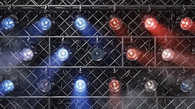Stage lighting equipment illuminates a dark venue with atmospheric smoke effects
