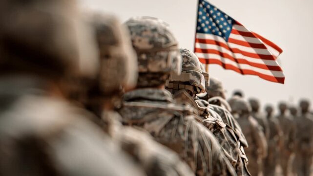 Soldiers standing in formation with American flag in background  