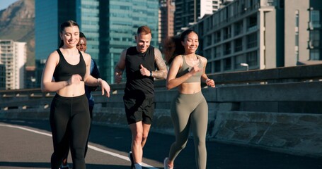 Obraz premium Happy people, fitness or running with friends in city street for cardio workout or outdoor exercise. Active, group or runners with smile on road for physical activity, race or training in urban town