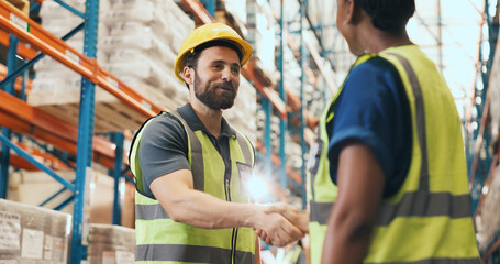 Business people, logistics and storage with handshake for teamwork or partnership together. Colleagues, employees or shaking hands with flare for shipping deal, b2b or onboarding in warehouse depot © peopleimages.com