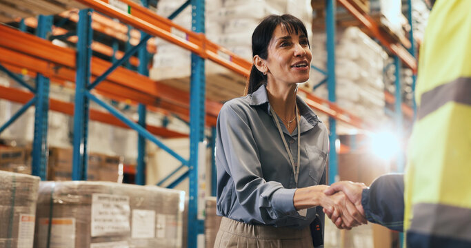 Happy woman, warehouse and logistics with handshake for partnership, b2b or shipping service. Female person, supplier or distributor shaking hands with smile for storage agreement or deal in depot