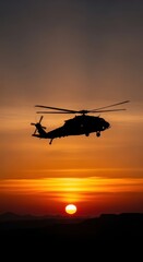 Obraz premium Helicopter Flying Against Stunning Sunset Sky Over Mountain Range