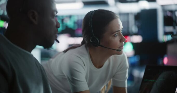 Diverse Team Traders Discussing Urgent Market Strategy During Volatility. Male Trader and Female Colleague Intensely Collaborate in Futuristic Financial Hub. Concept Collaborative Crisis Management.