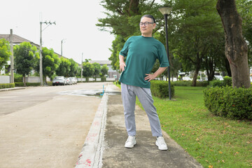 Fototapeta premium Asian senior man stretching their bodies during exercise in a park
