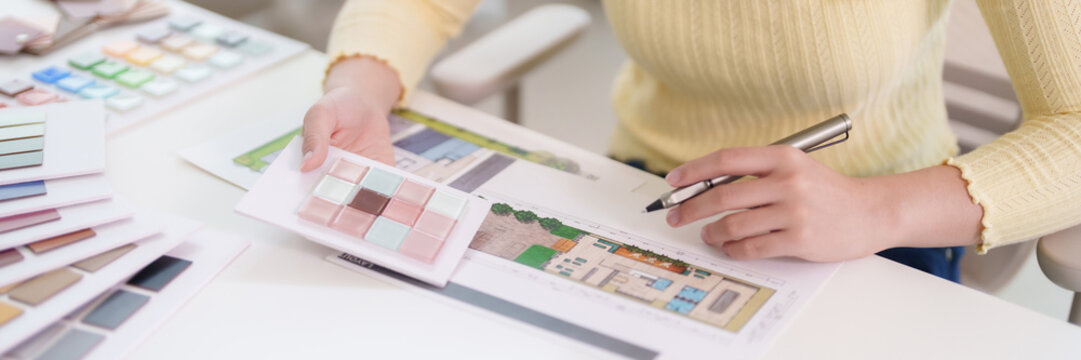 Asian adult woman designer hand holds tile samples plans work creating home improvement projects selecting materials interior design studio creating beautiful spaces for clients