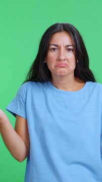 Confused woman shrugging shoulders with doubtful expression