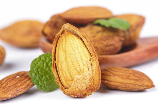 Fresh Shelled Almonds with Green Leaves - Healthy Natural Nuts and Kernels on White Background