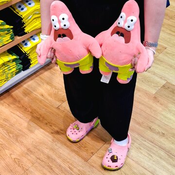 Close up of Patrick Star plush toy from SpongeBob SquarePants collection on display at Uniqlo in shopping mall for pop culture merchandise background on January 30, 2025 in Bangkok, Thailand