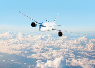 White passenger airplane flying in the sky amazing clouds in the background - Travel by air transport