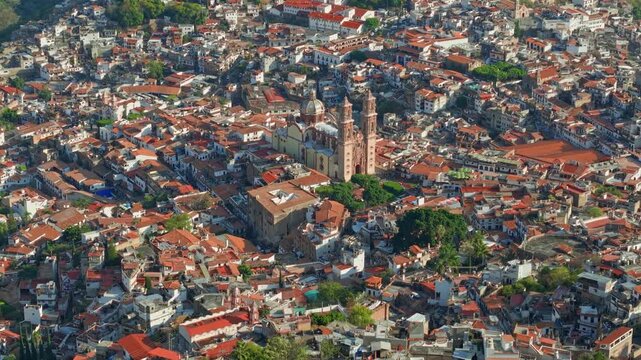 Telephoto bird's-eye view of the colonial streets of Taxco, with the Santa Prisca temple and tile roofs in the state of Guerrero, Mexico
