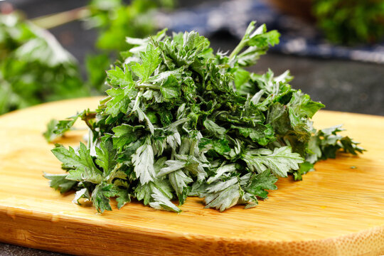 Freshly Harvested Wild Chenopodium Greens on Wooden Cutting Board - Edible Medicinal Plant