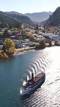 TSS Earnslaw Queenstown Historical Cruise on lake, aerial vertical. Autumn, New Zealand.