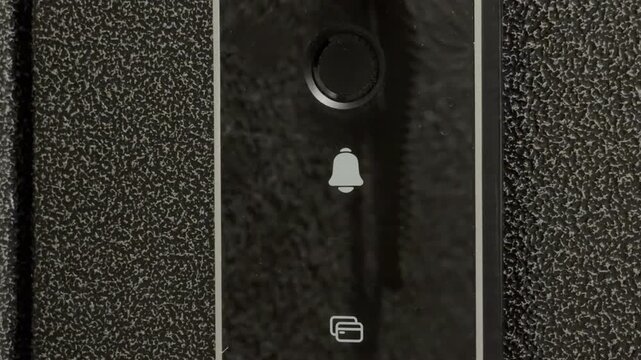 A person presses the bell icon on a digital smart lock panel. This action engages the electronic deadbolt, resulting in a firm mechanical sliding click and a short electronic confirmation beep.