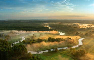 Naklejka premium Beautiful spring morning over the forest and river - drone aerial view