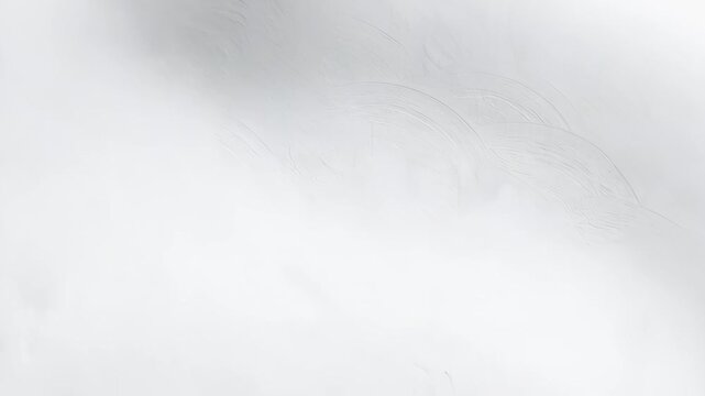 Aerial view of a fresh white snowy field with subtle tracks and wind patterns in a winter landscape