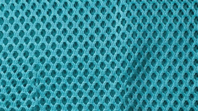 Closeup of a textured aquamarine blue color netting or mesh fabric