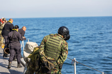 Naklejka premium military sailors search and rescue drowning people at sea 