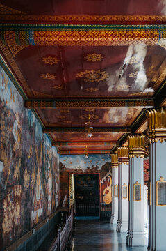 Ornate temple corridor with mural paintings at Grand Palace Bangkok