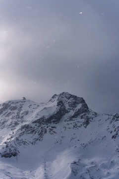 Moody view of clouds covering a mountain peak.