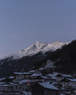 Alpine village nestled in a valley below the mountains