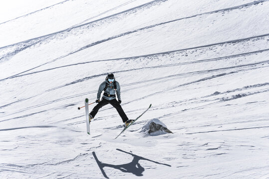 Skier landing a jump on a powder day