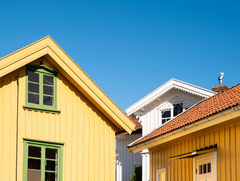 Facades of yellow and white wooden houses on Gullholmen island in Bohusl&auml;n, west coast Sweden