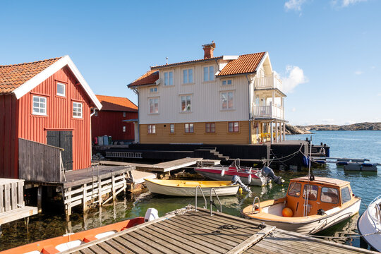 Waterfront houses, boats and wooden jetty on Gullholmen island in Bohusl&auml;n Archipelago, west coast Sweden