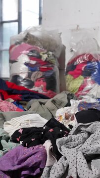 Used childrens clothes and shoes in bales for donation. Fast fashion clothing waste and overconsumption concept