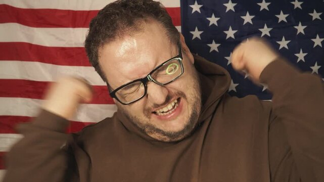 A football fan rejoices at his team's victory and shouts hurray.