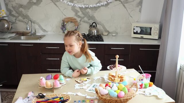 Wide shot of daughter are preparing for the Easter holiday together. Little cute girl play with rabbit glove