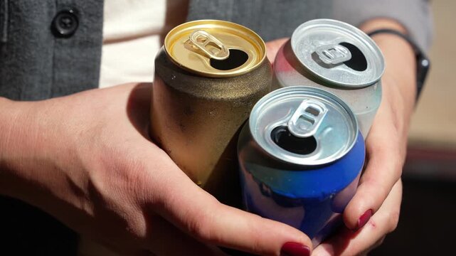 Woman collecting empty cans for scrap metal recycling