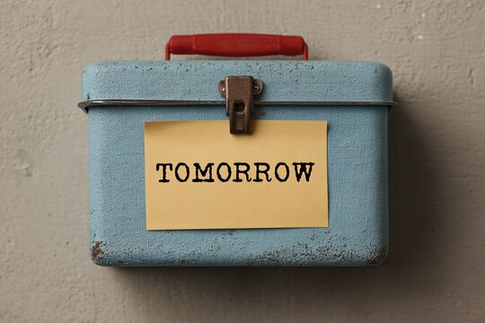 Empty lunchbox with note tomorrow in minimalist setting inspiring reflection on future plans
