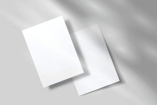 Minimal blank white A4 paper sheets mockup on background with elegant organic shadow overlay. Perfect for displaying stationery designs, flyers, posters, branding, Ads and print design presentations