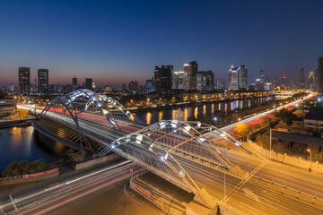 Fototapeta premium Tianjin Night View - Illuminated Bridges and City Skyline at Dusk