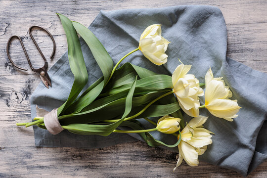 Bouquet of spring green tulip flowers on wooden background in studio