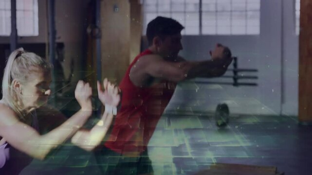 Man and woman synced taking short approach, jumping onto wooden plyo box landing squat for fitness