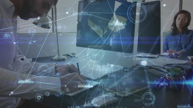 Seated man noting monitor for technology planning, HUD animating around desk as camera pulling back
