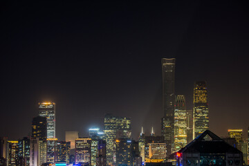 Fototapeta premium New York City Skyline at Night with Illuminated Skyscrapers