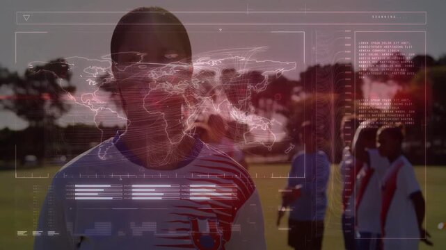 Turning woman facing forward on sports field, striped top, teammates right with red sash, HUD map