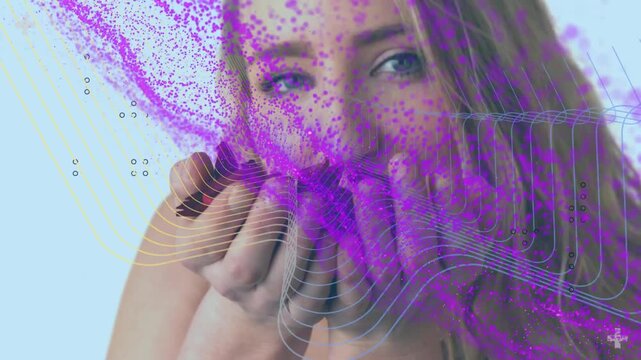 Blowing woman posing with cupped hands to mouth, releasing purple stream across studio, strapless