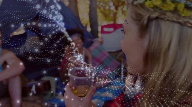 Marketers watching woman turning, raising cup, toasting friends while dotted wave overlaying picnic